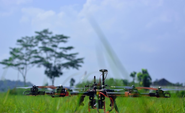 Multirotors on field against sky